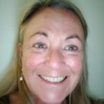 Vicki Whitley headshot. Vicki has long blonde hair and is wearing a black short sleeved top. She is smiling at the camera.