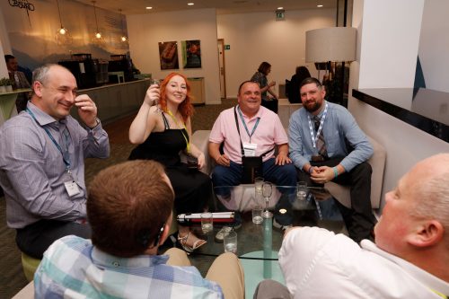 Small group of conference delegates and sighted guide at the drinks reception at the end of day one of the conference, before the opening of the Rodney Powell Awards for Volunteering.