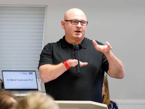 Key note speaker Mark Fosbrook talking into a microphone. Mark is a paralympic champion and former player for the Great Britain Wheelchair Basketball Team.
